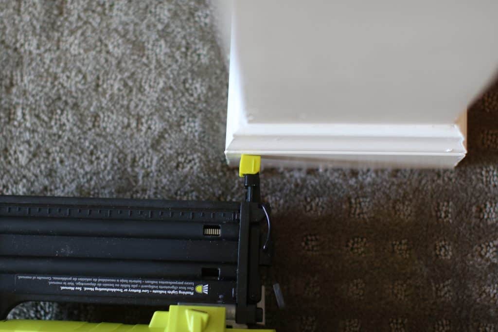 Close up of a brad nailer working on wood