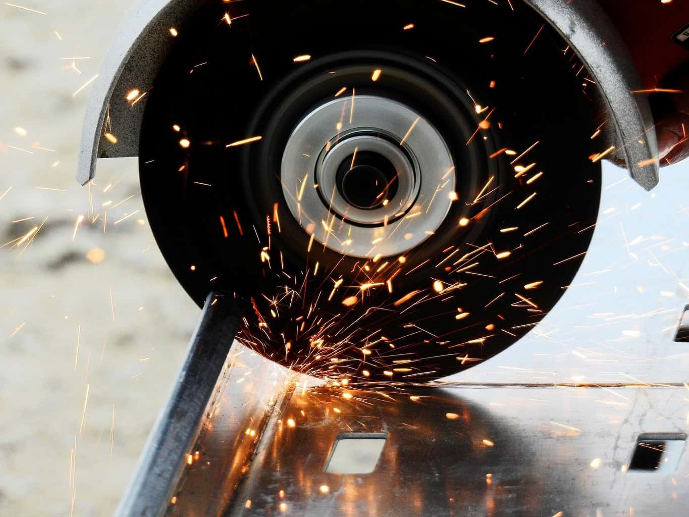 An angle grinder cutting through metal