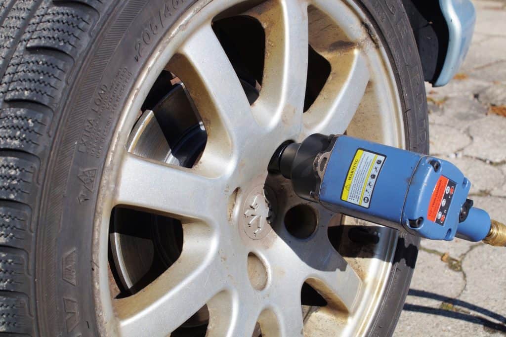 Impact wrench being used to remove nuts off a tire