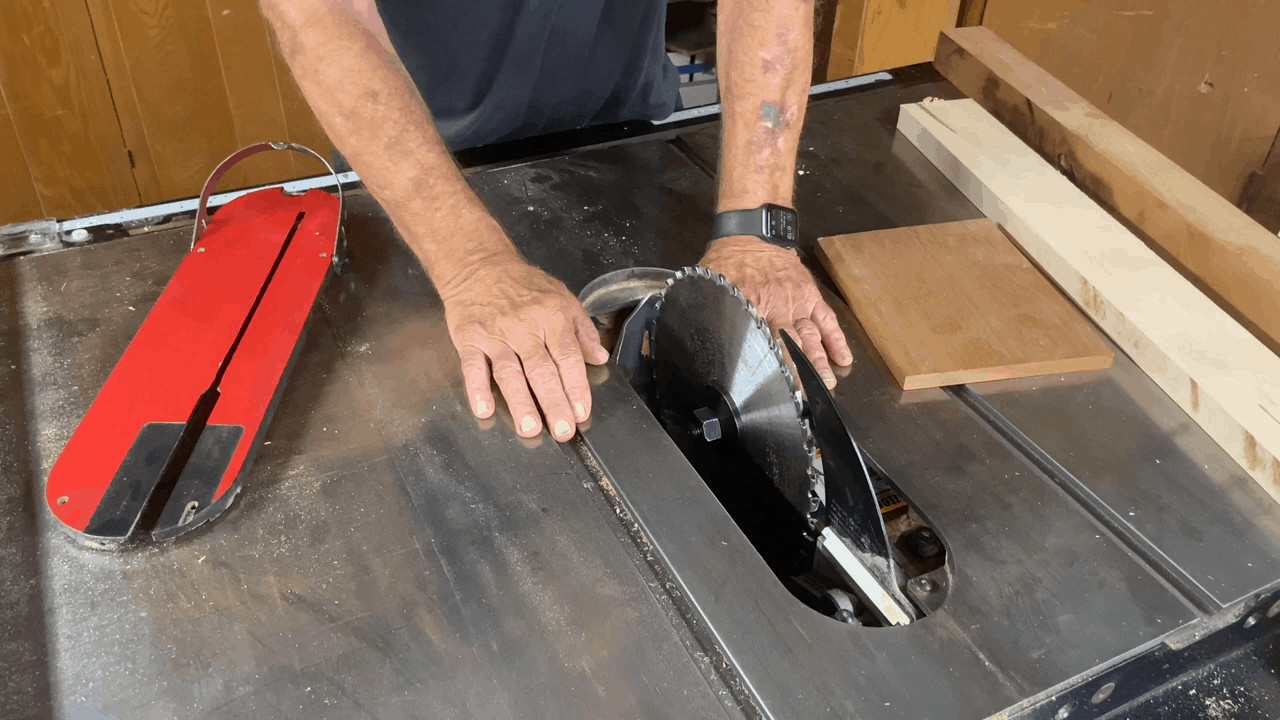 Person adjusting the table saw blades