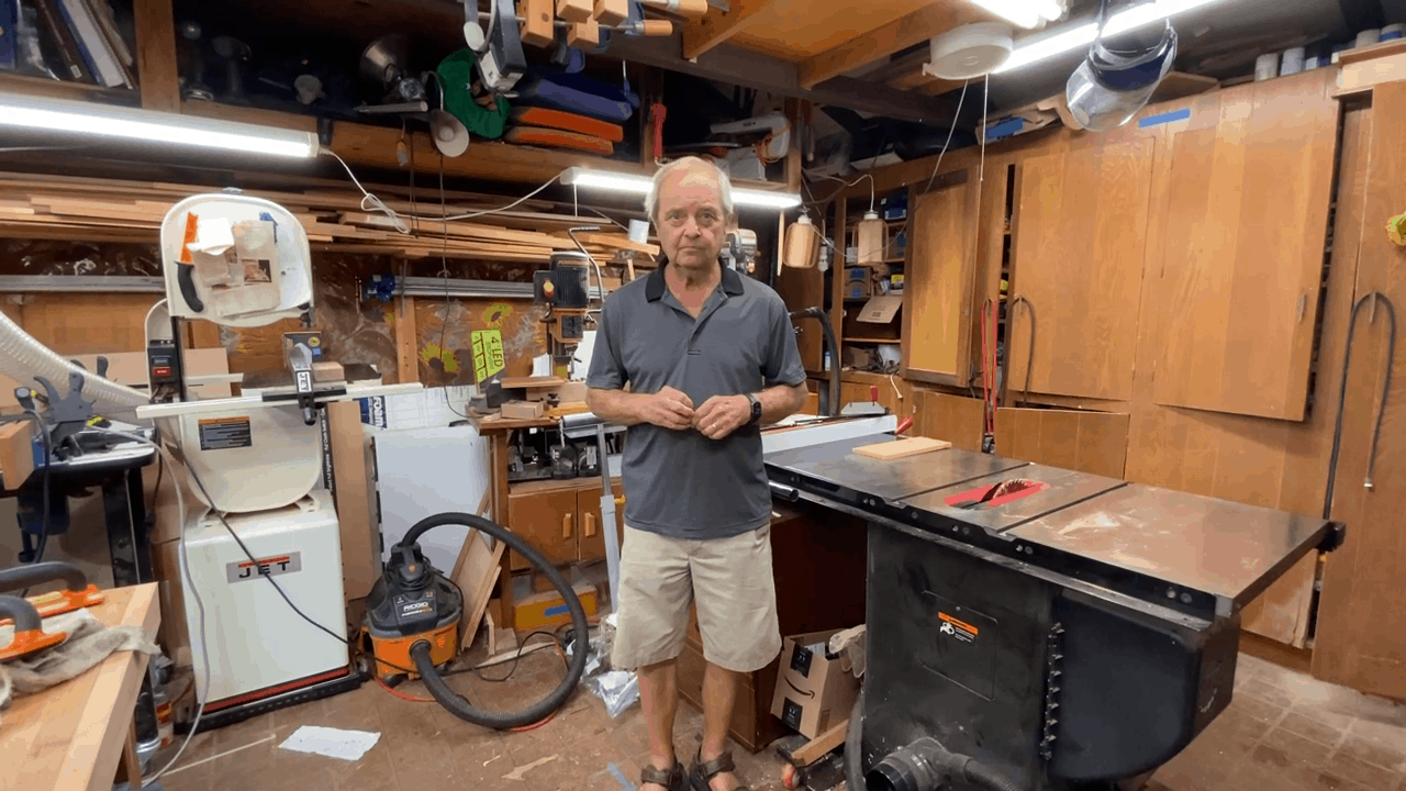 Man standing beside a table saw