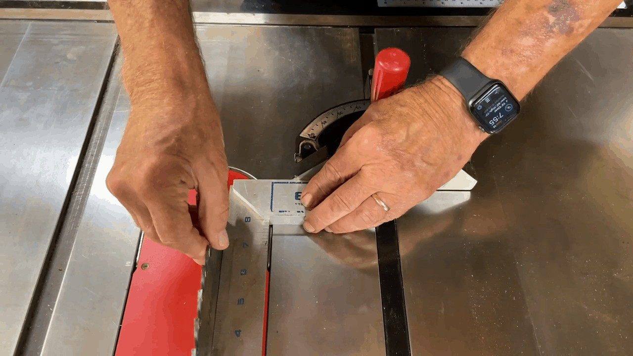 Man trying to demonstrate what is runout on a table saw arbor