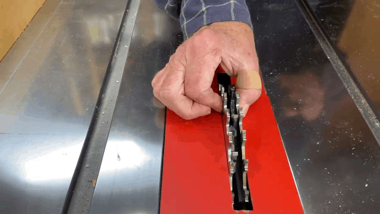 Person shows which way do the blade teeth go on a table saw