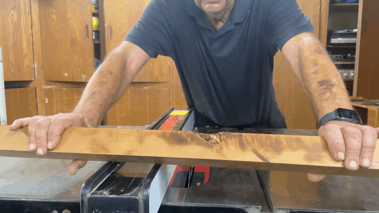 Man showing why is his table saw marking the wood
