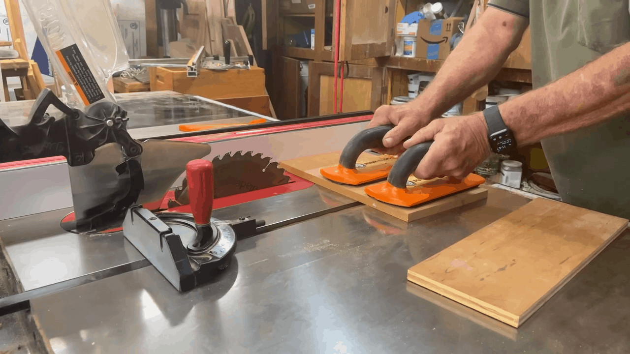 Man using a push block while using his table saw