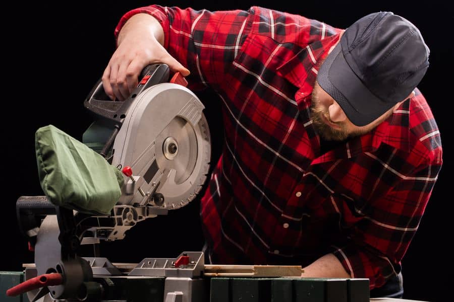 Man about to change the blades in his miter saw